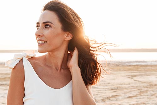 woman standing on beach outside mental health housing