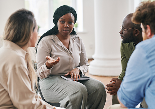 men and women participate in group therapy as part of a marijuana detox program