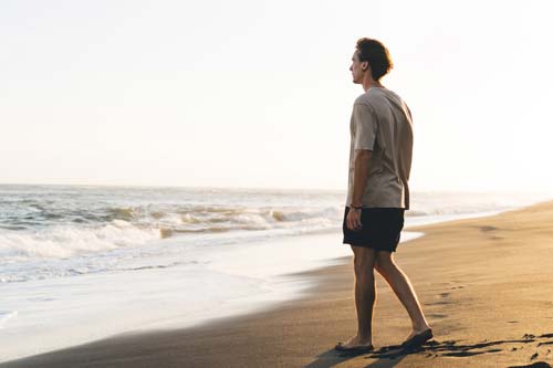 a man walking on a beach