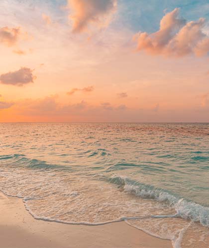 a beach with waves and a sunset