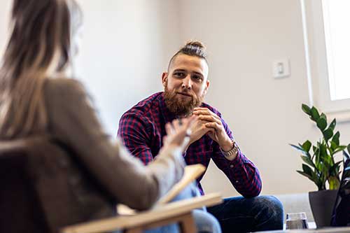a man sitting in a room with a woman