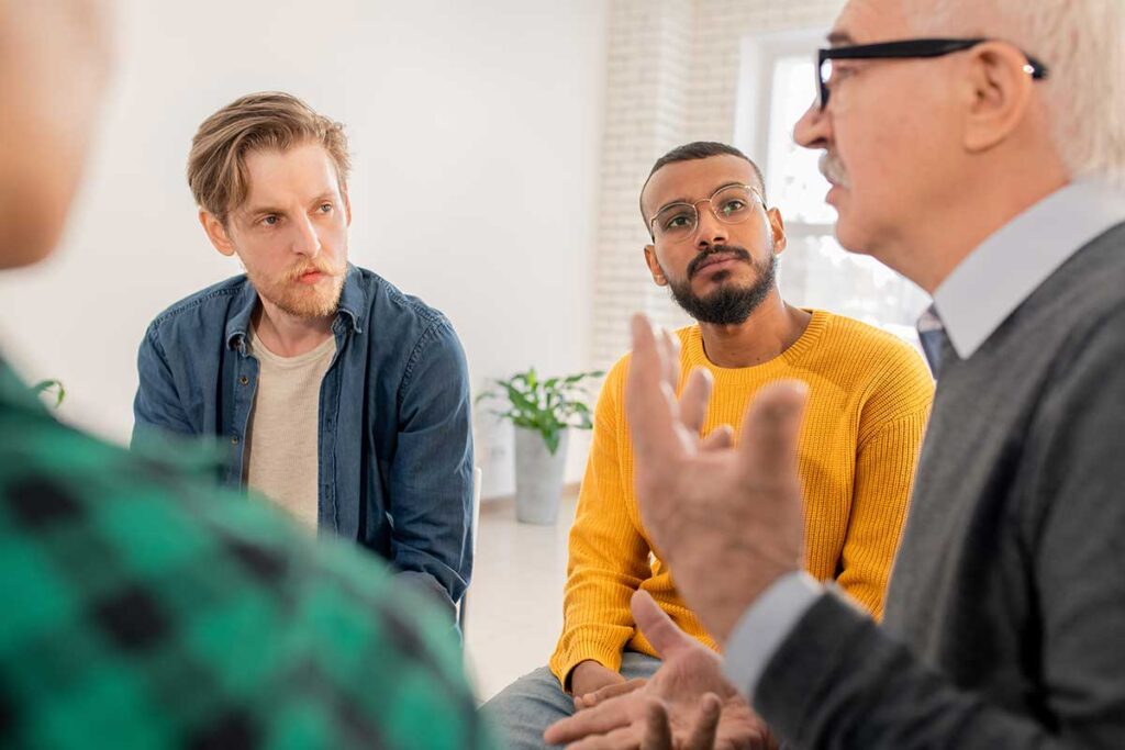 a group of men sitting in a circle